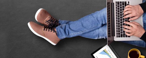 Man Sitting On Floor Working on a Laptop