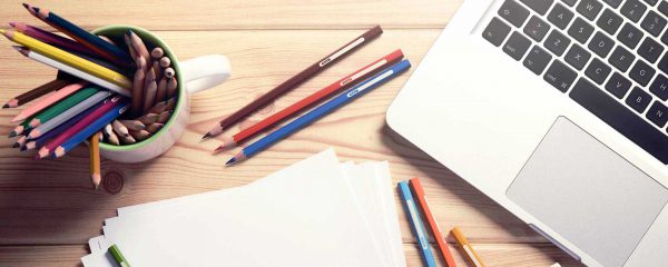 Laptop with Colored Pencils and Paper